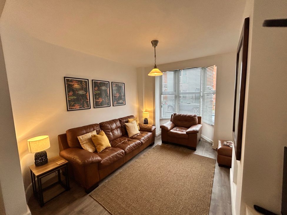 A living room with a sofa and armchair at The Weymouth House in Weymouth