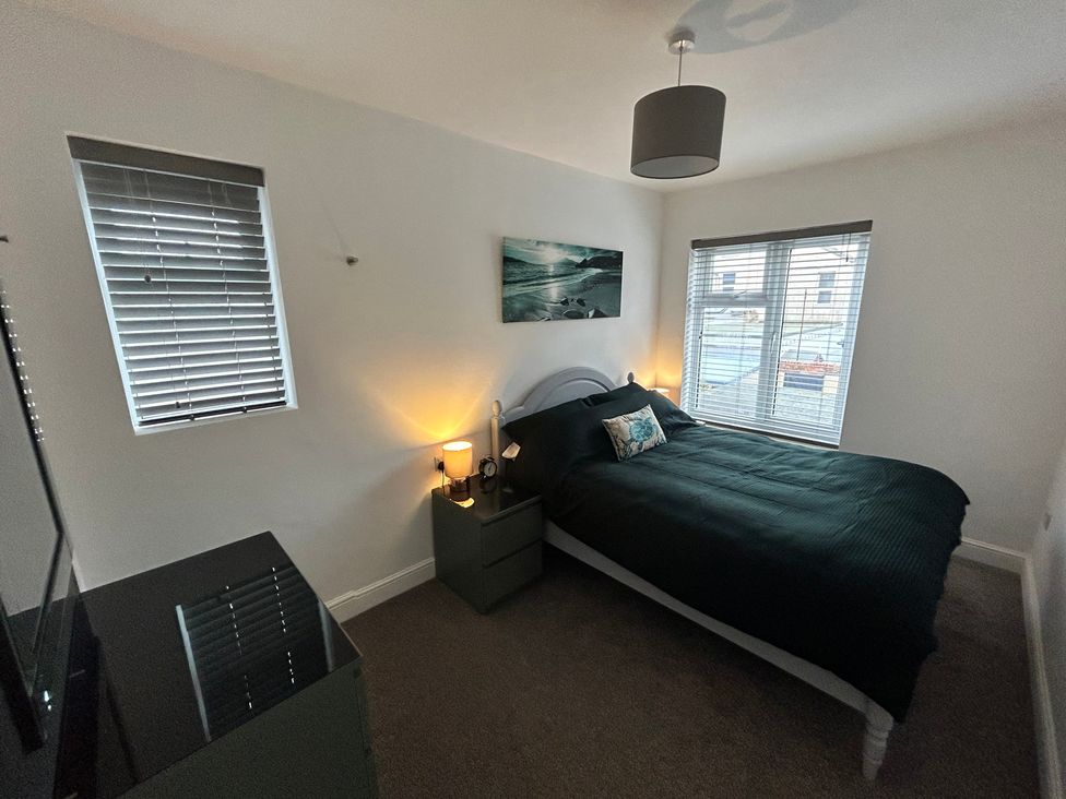 A bedroom with a bed and bedside table at The Weymouth House in Weymouth