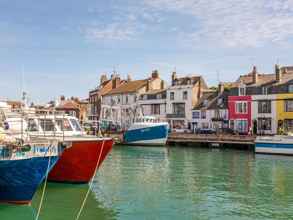 Boats in the harbor with buildings in the background at The Weymouth House in Weymouth