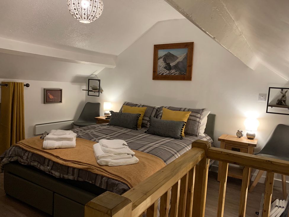 A bedroom with a bed and bedside tables at The Haven in Penrith