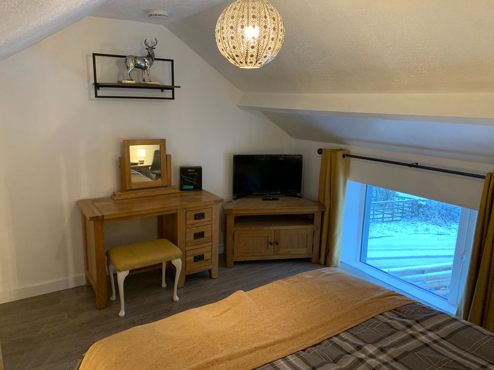 A bedroom with a bed and desk at The Haven in Penrith