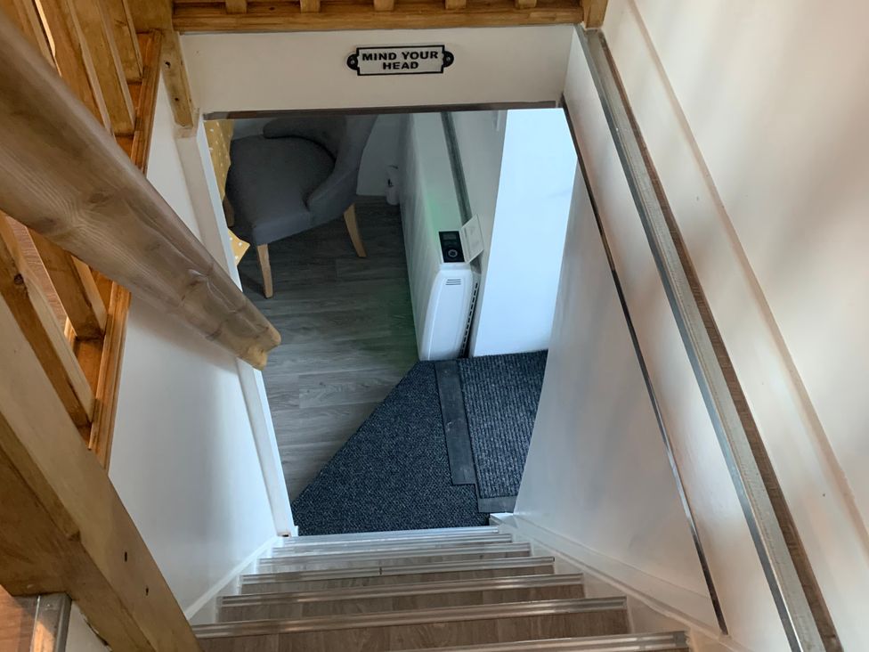 A staircase leading to a doorway with a sign at The Haven in Penrith