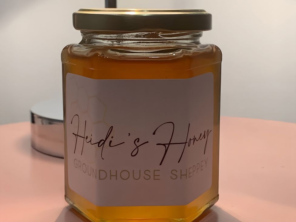 A honey jar with label on a table at Cosy Escape in Sheerness