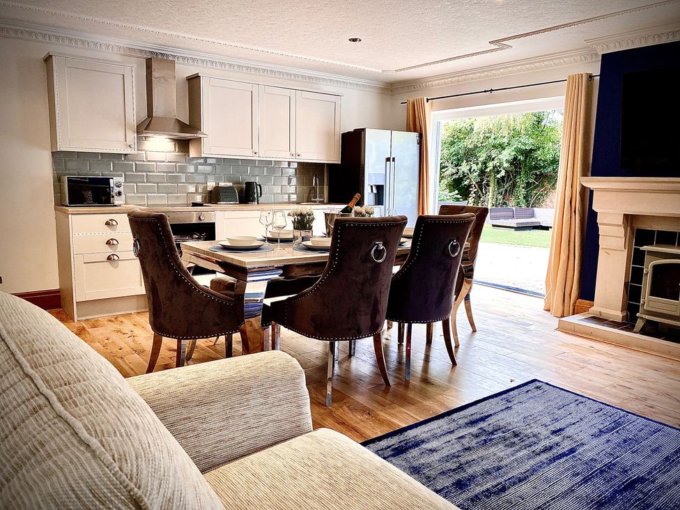 A kitchen with a dining area and appliances at Anchor Hot Tub Suite in Lytham St. Annes