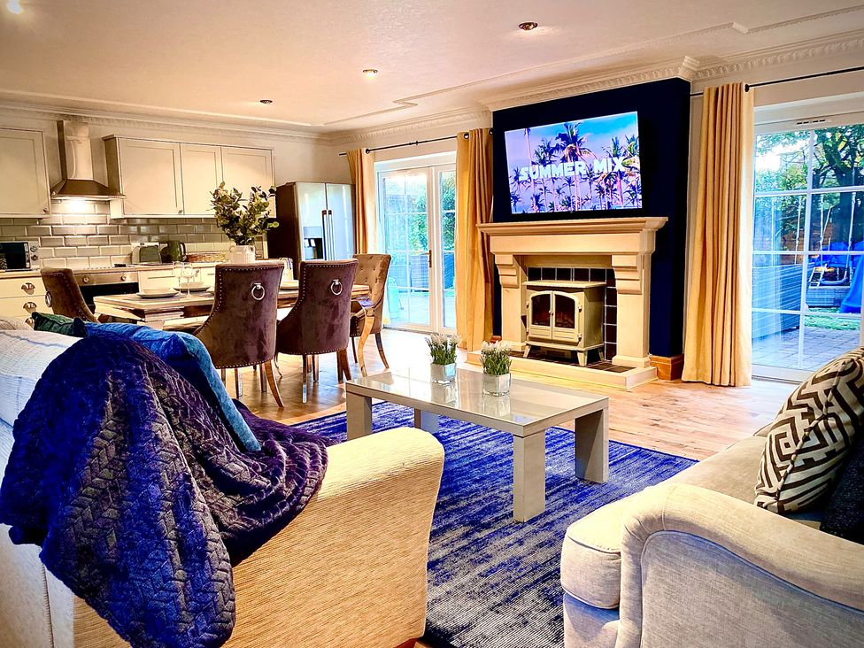 A living room with a fireplace and television at Anchor Hot Tub Suite in Lytham St. Annes