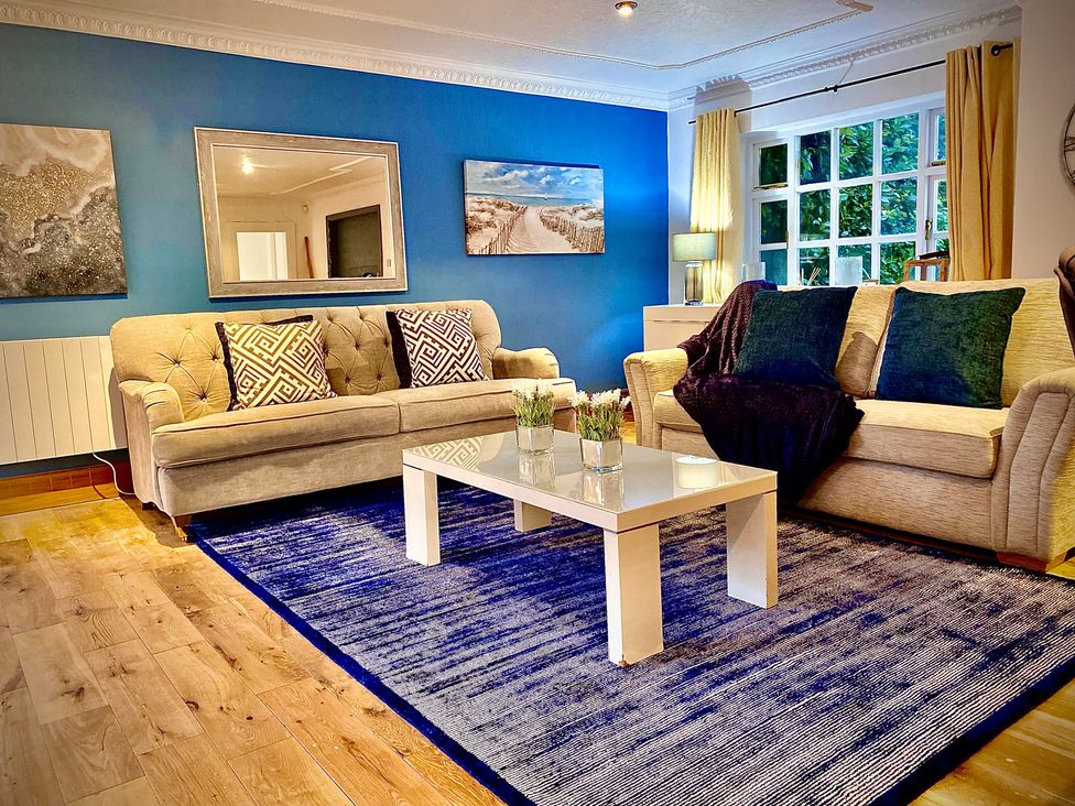 A living room with sofas and a coffee table at Anchor Hot Tub Suite Lytham St. Annes