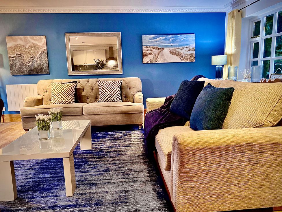 A living room with two sofas and a coffee table at Anchor Hot Tub Suite in Lytham St. Annes