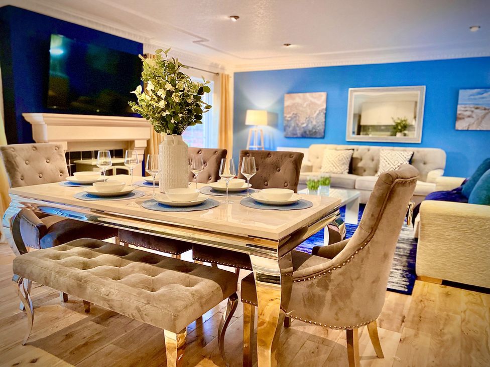 A dining room with a table and chairs at Anchor Hot Tub Suite in Lytham St. Annes