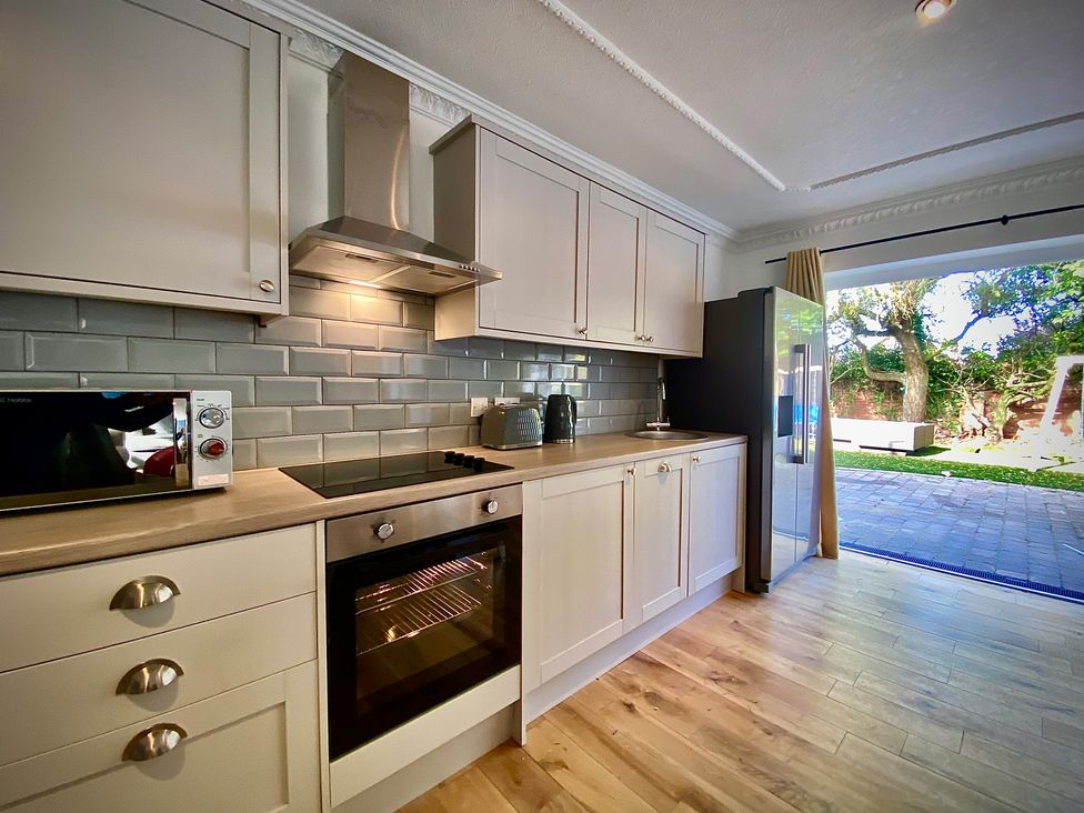 A kitchen with appliances and cabinets at Anchor Hot Tub Suite in Lytham St. Annes