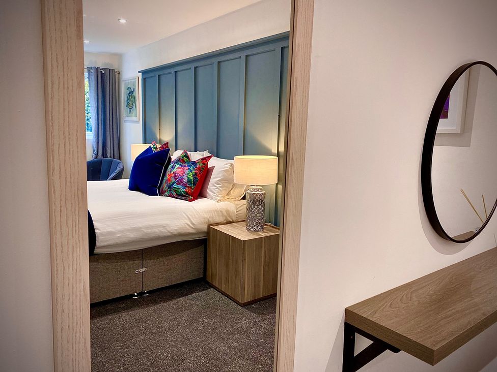 A bedroom with a bed and a bedside table at Anchor Hot Tub Suite in Lytham St. Annes