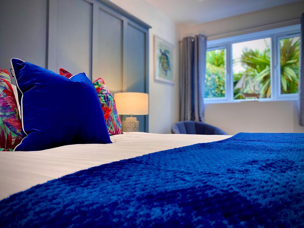 A bedroom with a bed and pillows at Anchor Hot Tub Suite in Lytham St. Annes