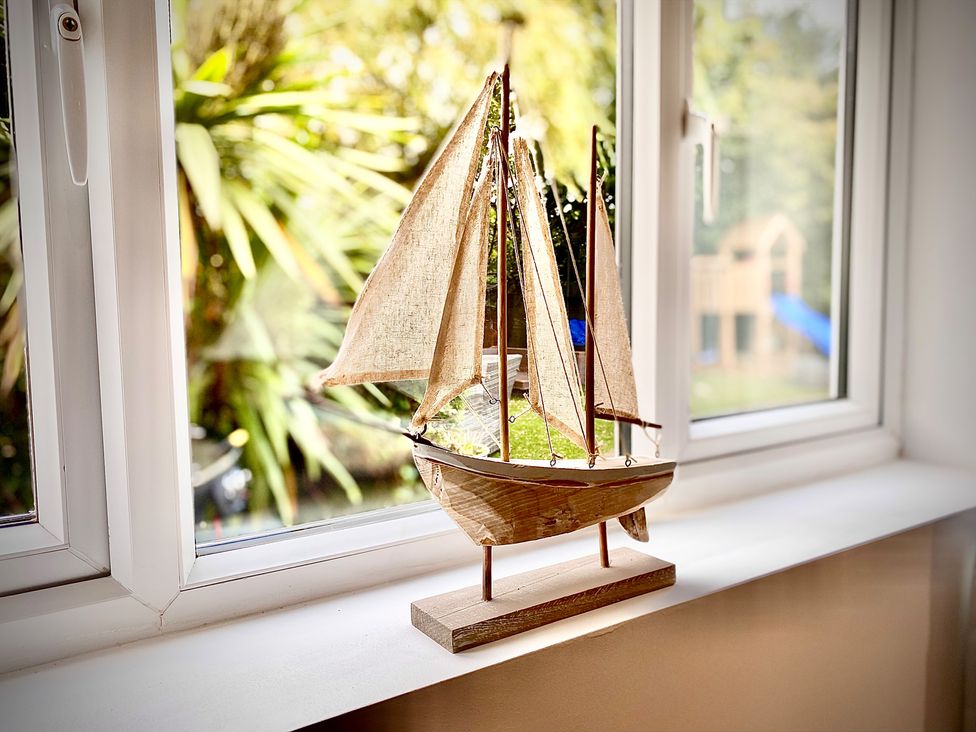 A sailboat decoration on a windowsill at Anchor Hot Tub Suite in Lytham St. Annes