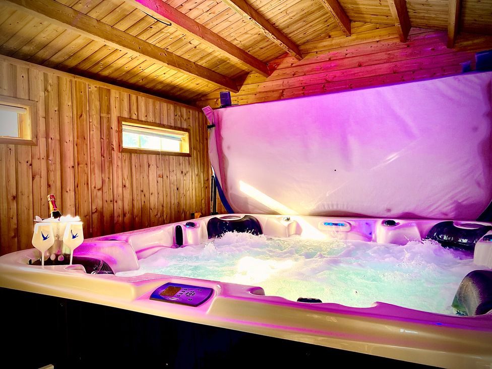 A hot tub with wine and glasses at the Anchor Hot Tub Suite in Lytham St. Annes