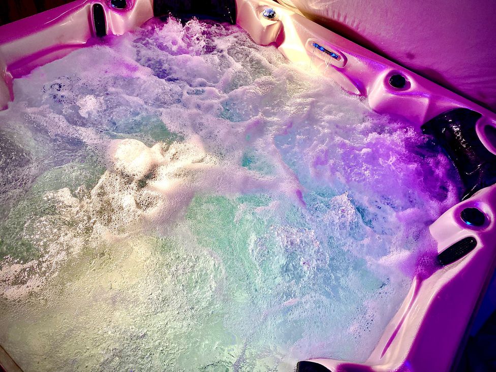 A hot tub with water and bubbles at Anchor Hot Tub Suite Lytham St. Annes