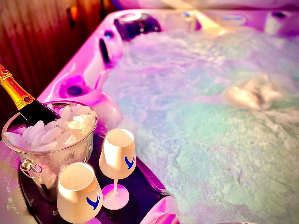 A hot tub with champagne and glasses at Anchor Hot Tub Suite in Lytham St. Annes
