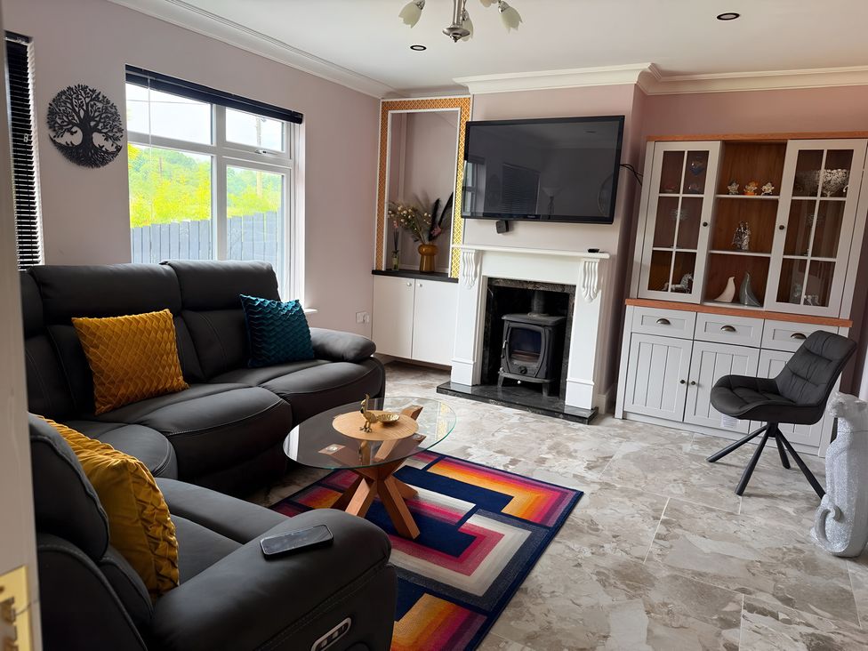 A living room with a sofa and coffee table at Cherry Chirp Cottage Enniskillen
