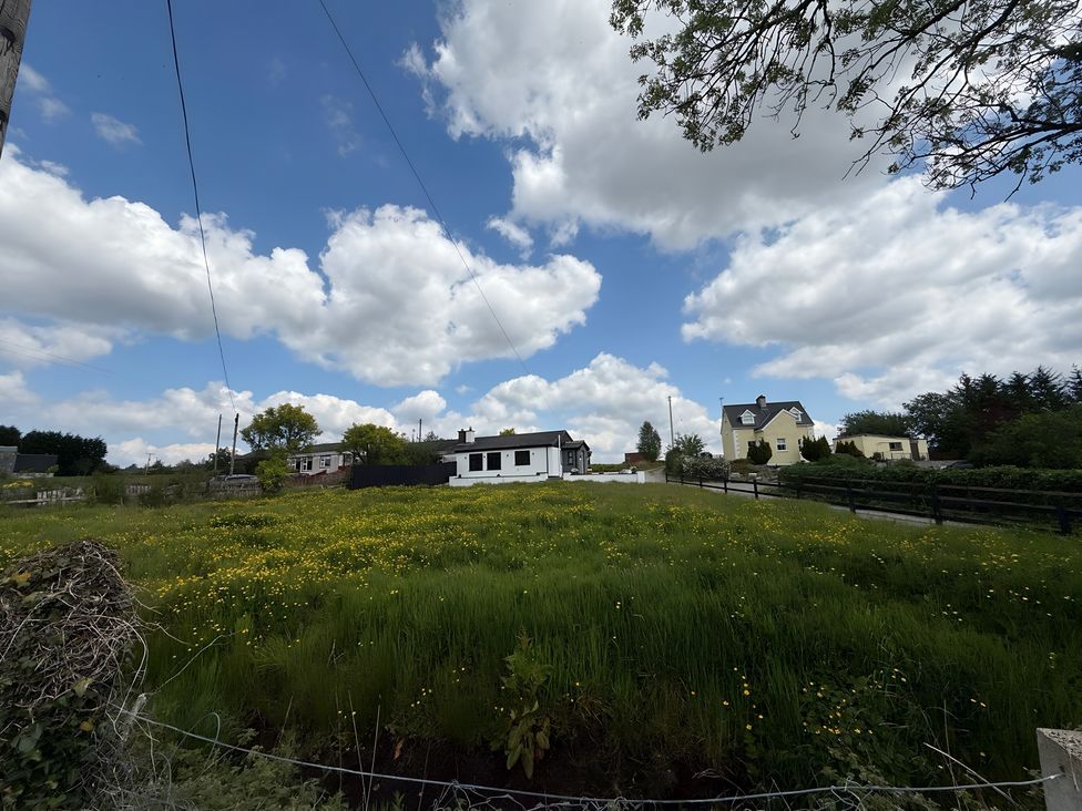 An outdoor view with houses and grass at Cherry Chirp Cottage Enniskillen