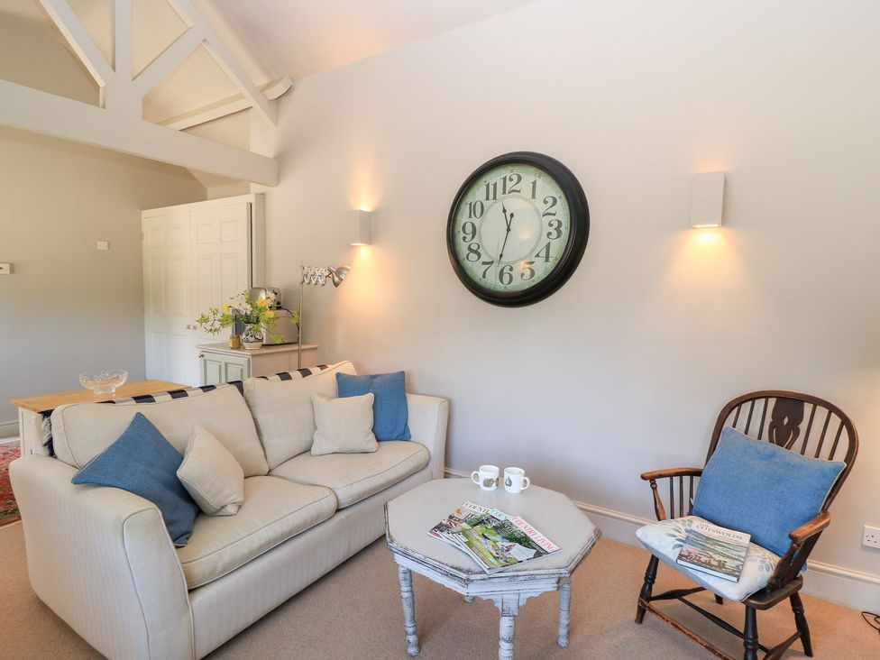 A living room with a sofa and armchair at Foxhill Farm Barn in Cheltenham