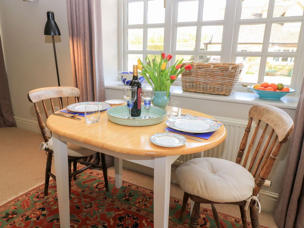 A dining room with a table set for meals at Foxhill Farm Barn in Cheltenham
