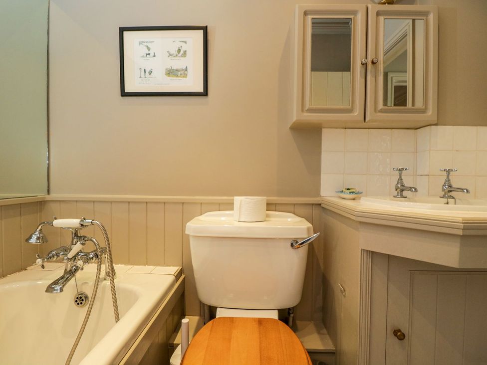 A bathroom with a bathtub, toilet, and sink at Foxhill Farm Barn in Cheltenham