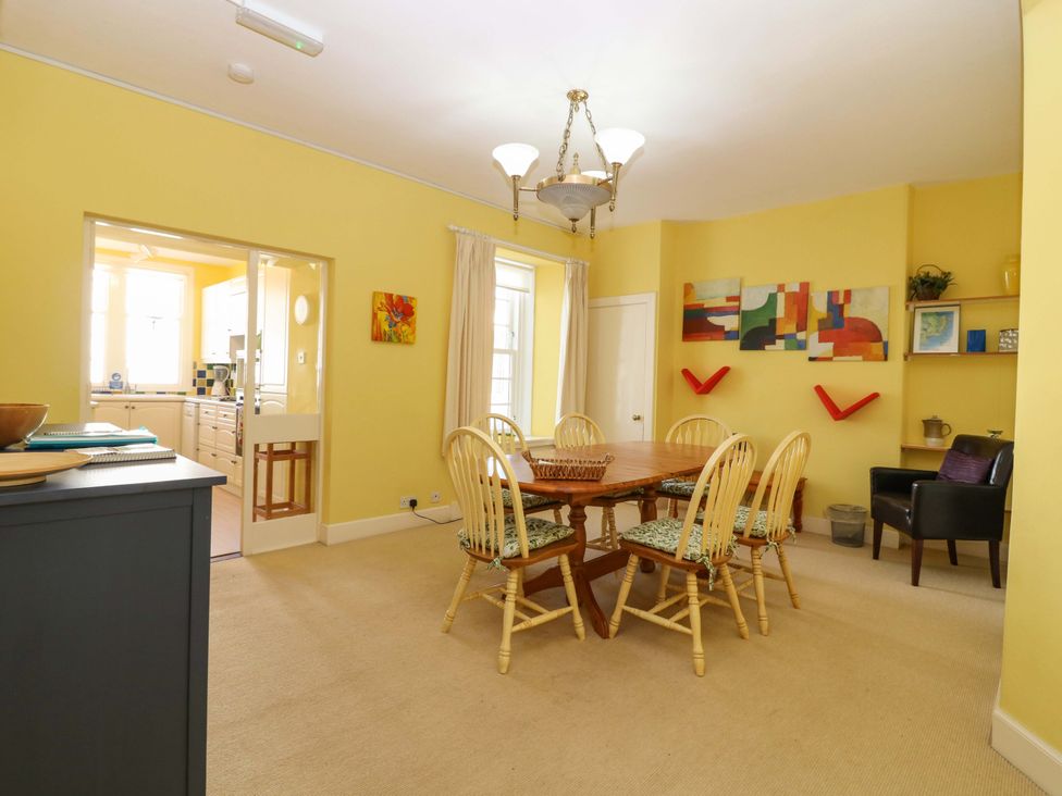 A dining room with a table and chairs at The Lighthouse Retreat in St Abbs