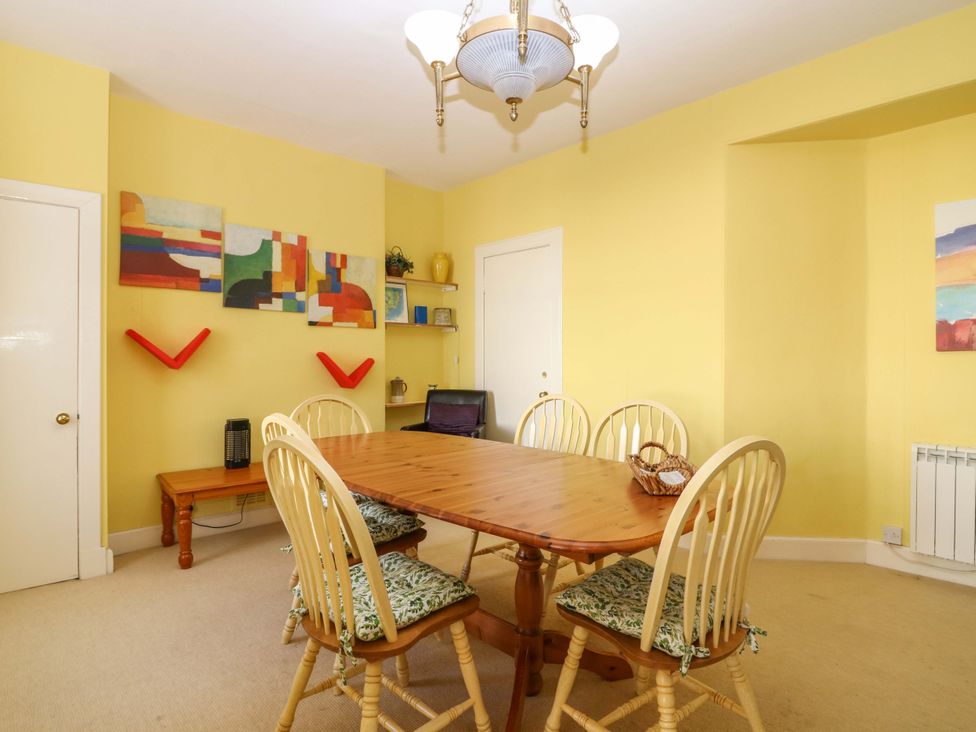 A dining room with a table and chairs at The Lighthouse Retreat in St Abbs