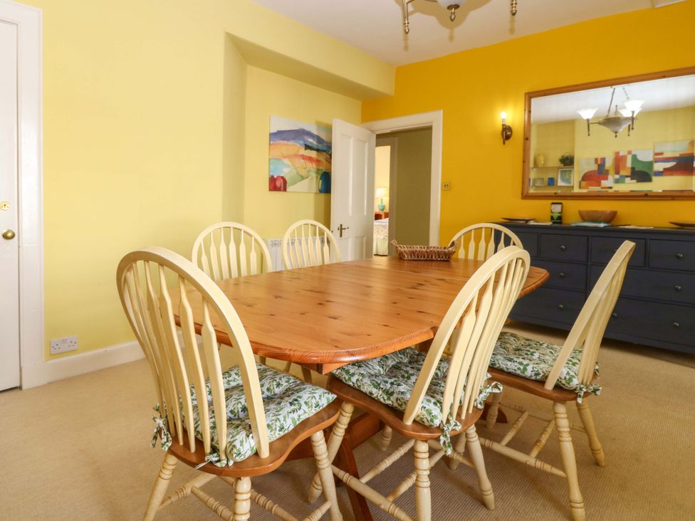 A dining room with a wooden table and chairs at The Lighthouse Retreat St Abbs