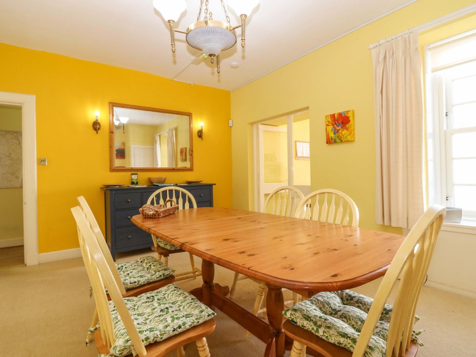 A dining room with a table and chairs at The Lighthouse Retreat St Abbs