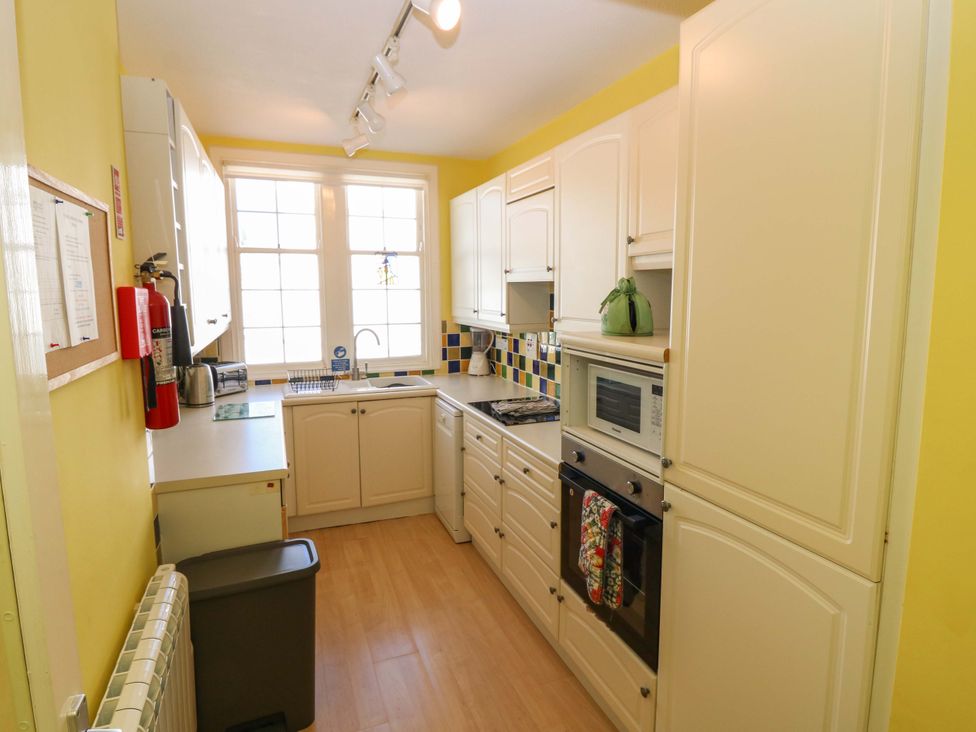 A kitchen with cabinets and appliances at The Lighthouse Retreat in St Abbs