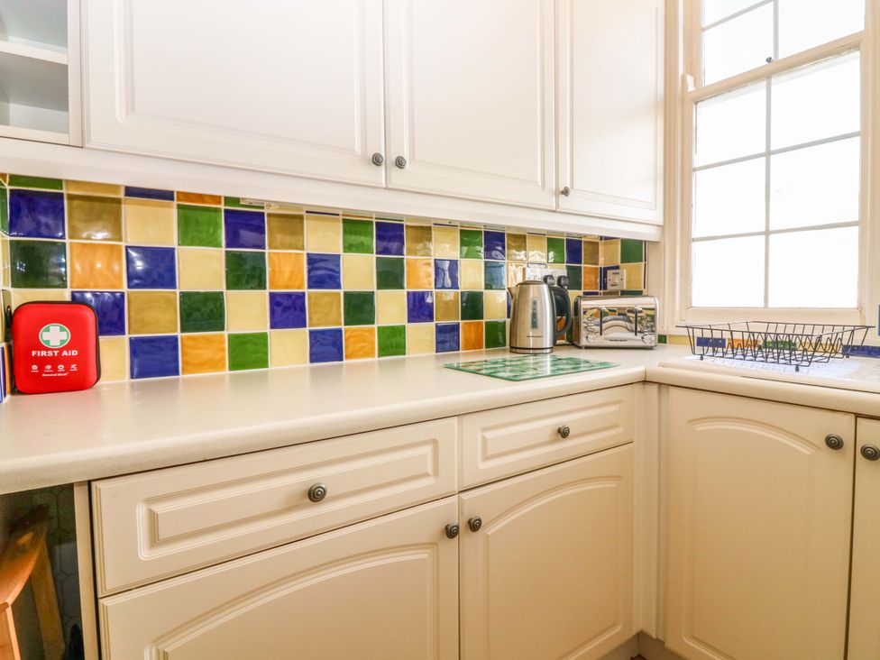 A kitchen with cabinets and appliances including a kettle and toaster at The Lighthouse Retreat in St Abbs