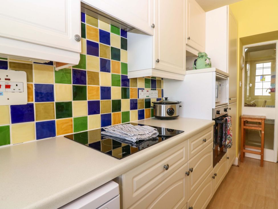 A kitchen with a stove and crockpot at The Lighthouse Retreat in St Abbs