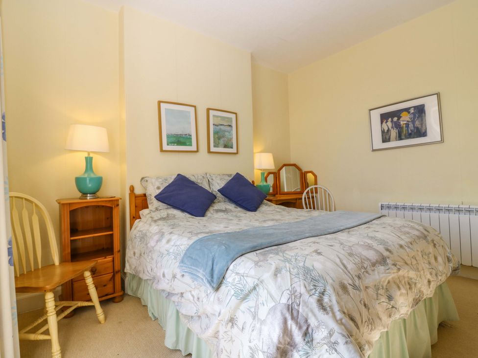 A bedroom with a bed and nightstand at The Lighthouse Retreat in St Abbs