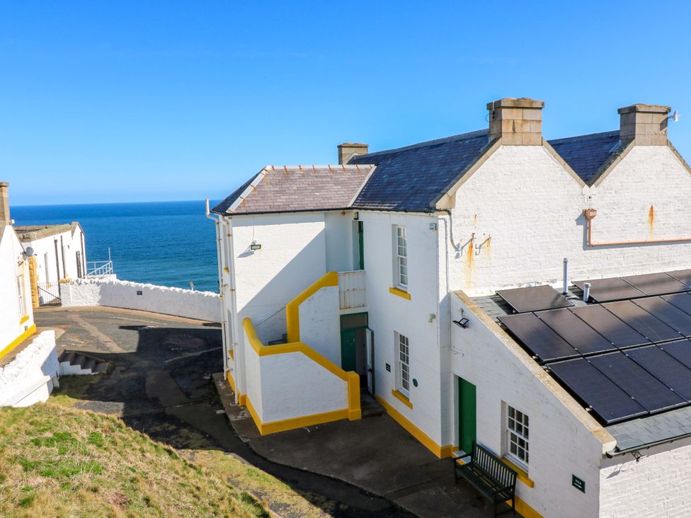 An outdoor area with buildings and sea view at The Lighthouse Retreat in St Abbs