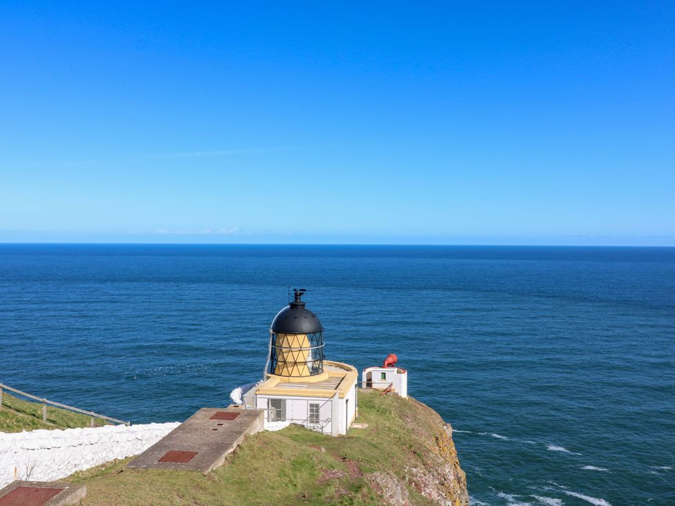 A lighthouse overlooking the ocean at The Lighthouse Retreat in St Abbs