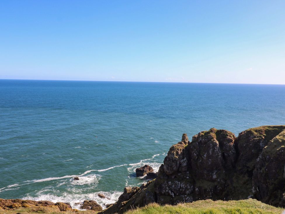 A coastal view of cliffs and ocean at The Lighthouse Retreat in St Abbs