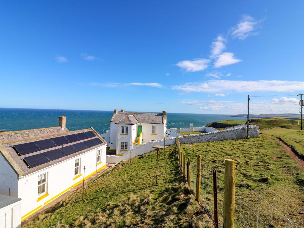 A house with solar panels and a view of the sea at The Lighthouse Retreat St Abbs