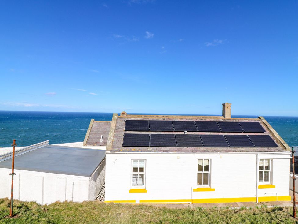 A building with solar panels and ocean view at The Lighthouse Retreat St Abbs