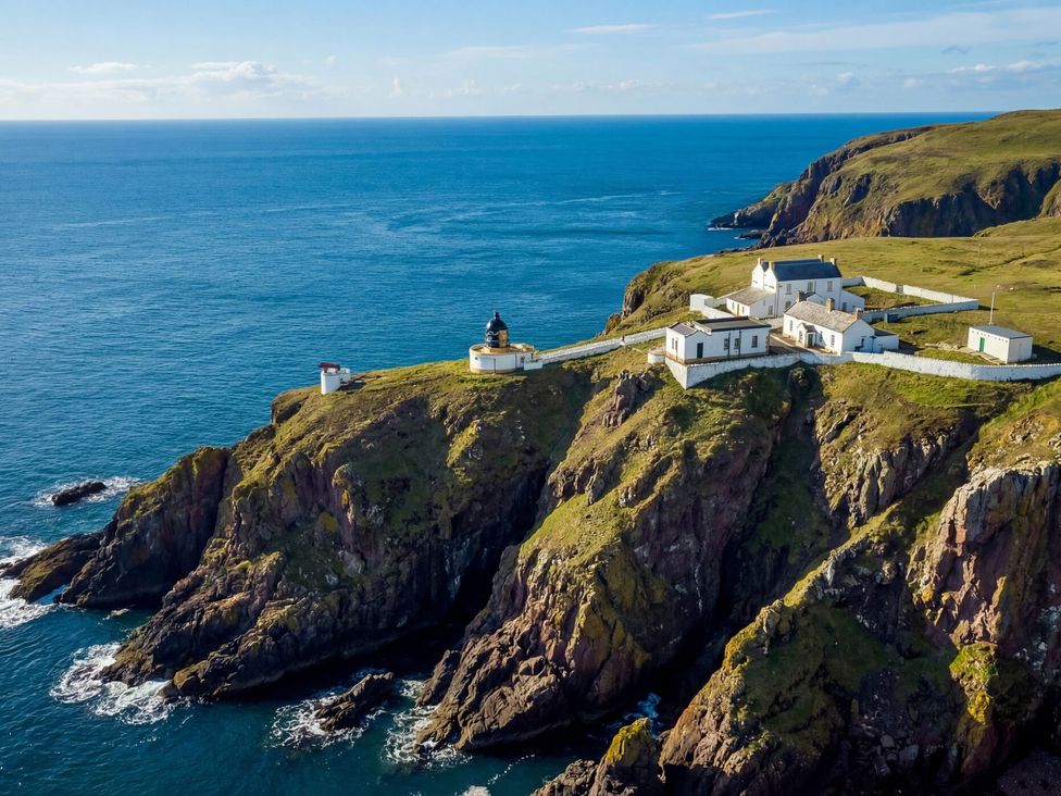 A lighthouse on a cliff overlooking the ocean at The Lighthouse Retreat in St Abbs