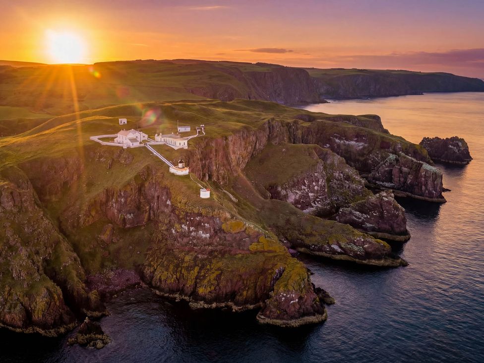 An aerial view of cliffs and a lighthouse at Keepers Fold at The Lighhouse St Abbs