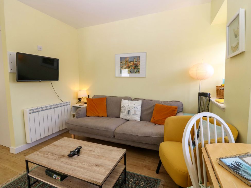 A living room with a sofa and coffee table at Keepers Fold at The Lighthouse St Abbs