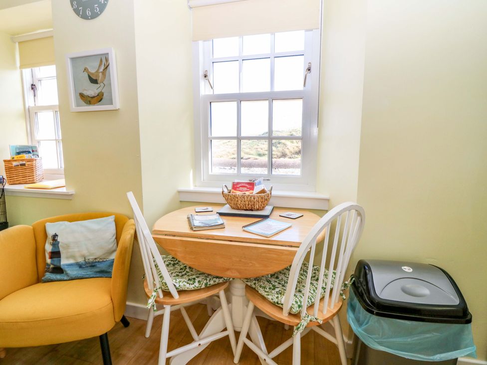 A dining area with a table and chairs at Keepers Fold at The Lighthouse St Abbs
