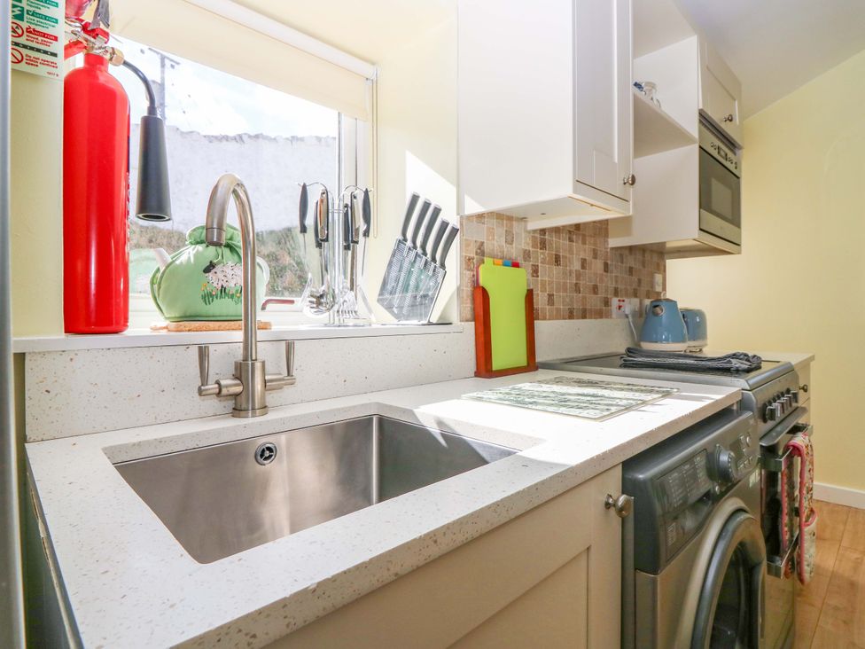 A kitchen with a sink, faucet, and cabinets at Keepers Fold at The Lighthouse St Abbs