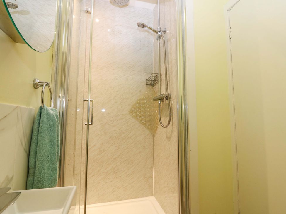 A bathroom featuring a shower with a towel and sink at Keepers Fold at The Lighthouse St Abbs