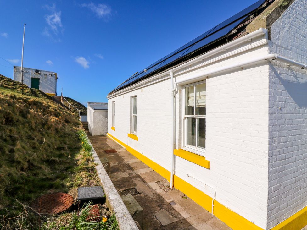 An outdoor view of a building with steps and a paved pathway at Keepers Fold at The Lighthouse St Abbs