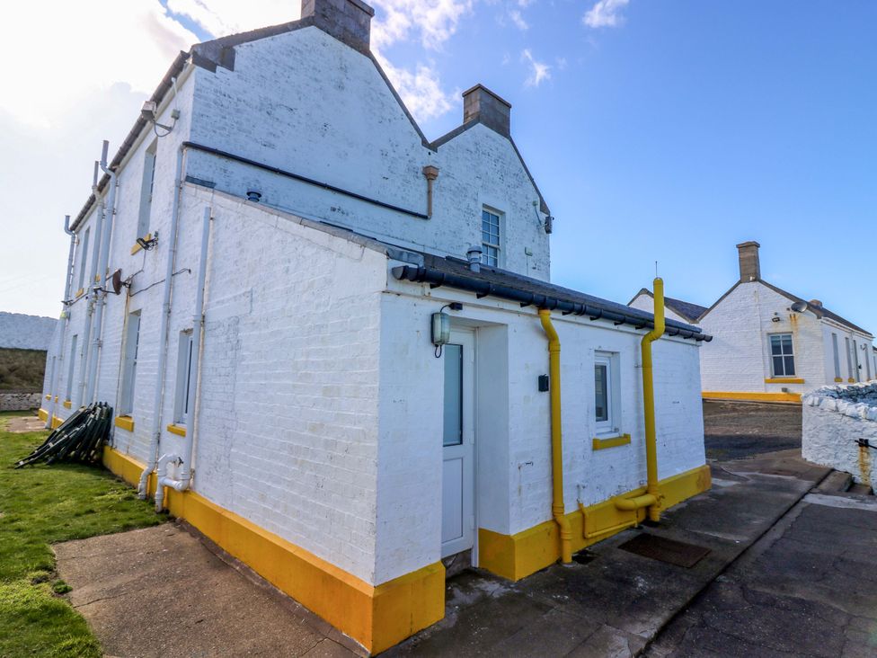 An exterior view of a house with a door and windows at Keepers Fold at The Lighhouse St Abbs
