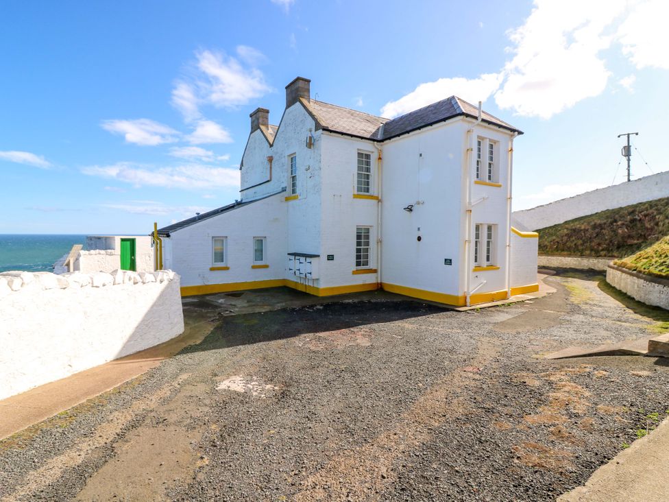 An outdoor area with a building near the ocean at Keepers Fold at The Lighthouse St Abbs