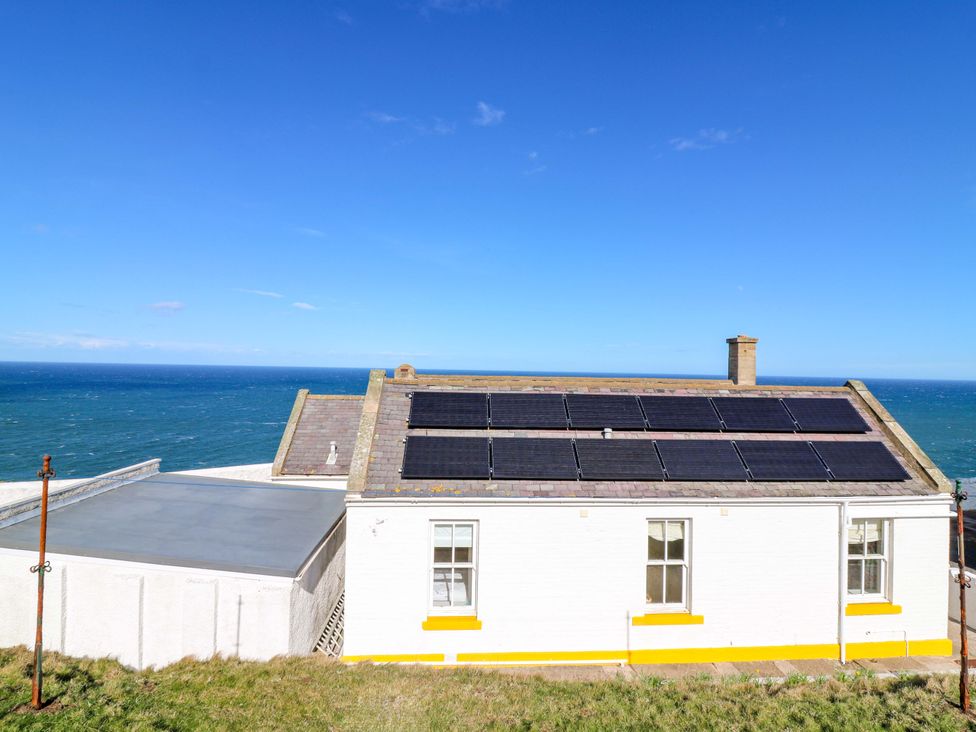 A house with solar panels roof and ocean view at Keepers Fold at The Lighthouse St Abbs