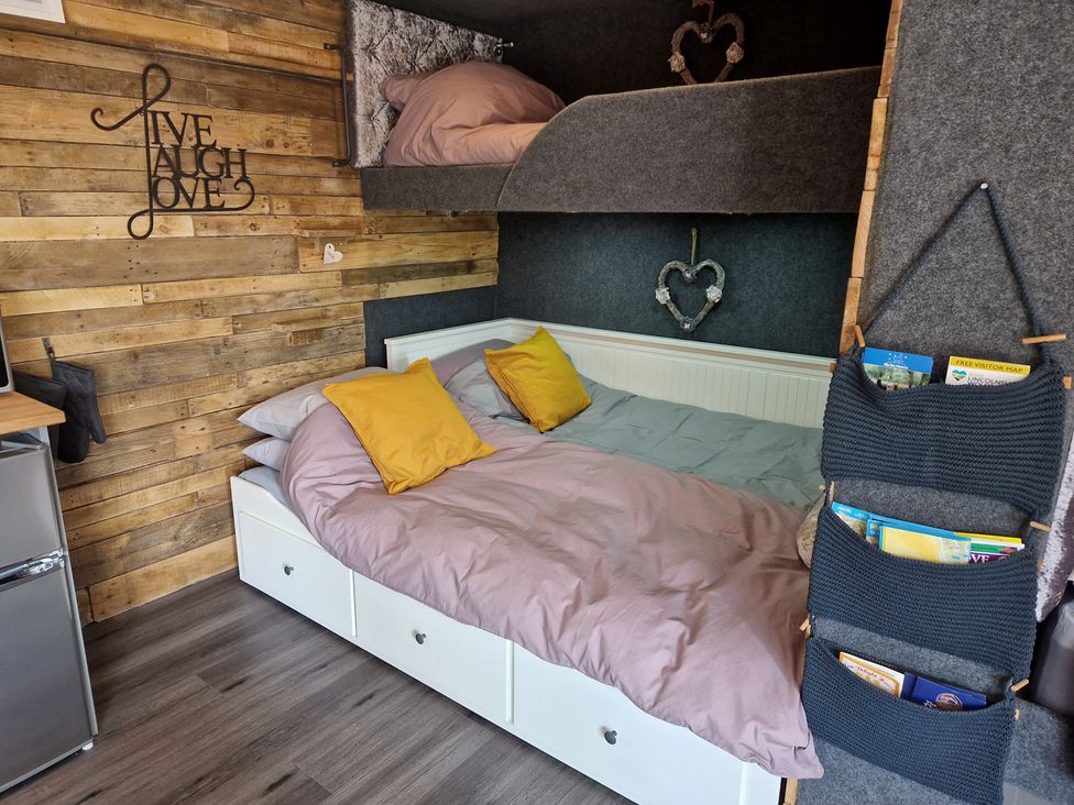 A bedroom with a bed and bunk bed at Birdsong lodge near Hawthorn Farm near Sutton-On-Sea