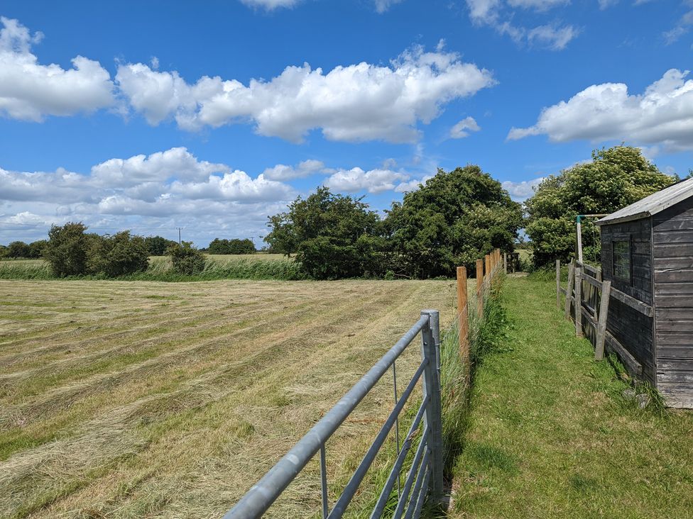 A field with a gate and shed at Birdsong lodge near Hawthorn Farm near Sutton-On-Sea