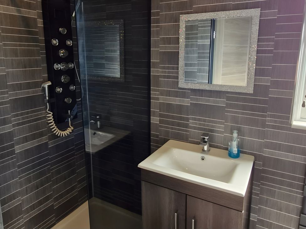 A bathroom with a shower and sink at Waterside Lodge in Mablethorpe